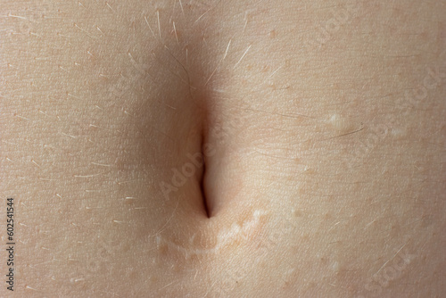 Young woman's belly button. Macro close up shot, unrecognizable person