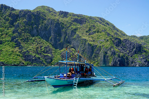 traditional wooden outrigger boats on palawan island