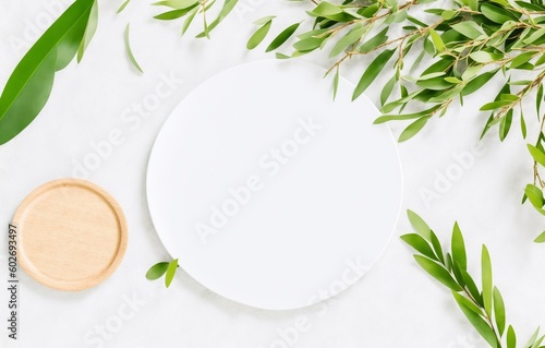 Summer wedding stationery mock-up scene. Blank greeting card, plate, olive tree leaves and branches in sunlight. White table background with palm shadows, generative ai
