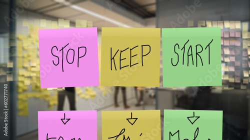 Three sticker written, "stop", "keep" and "start" on a window. Teams run retrospective board project feedbacks.