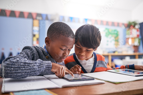 Digital tablet, school and students in classroom doing research for work, test or exam. Technology, education and boy children friends working on project or assignment together with mobile on campus.