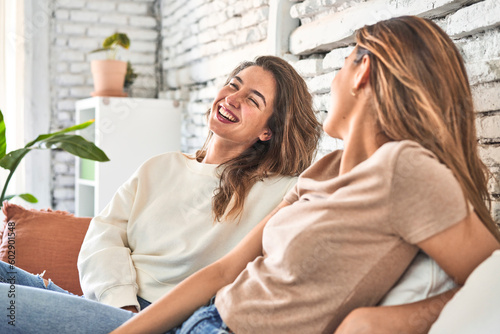 Friends bonding, laughing, and enjoying a cozy afternoon on the couch.