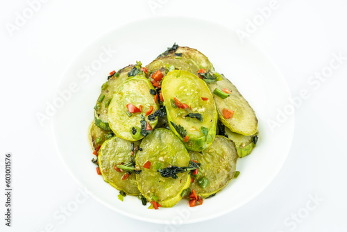 Fried cucumbers with perilla on a plate on a white background