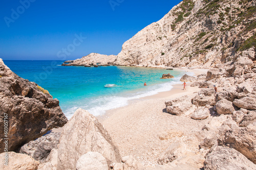  Petani Beach with white sand and azure water against blue sky - Kefalonia island, Ionian sea, Greece.