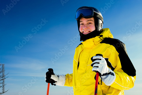 Happy smiling skier with sky in background