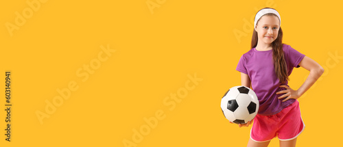 Sporty little girl holding soccer ball on yellow background with space for text