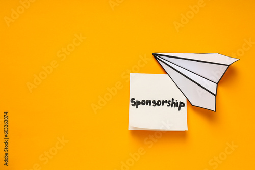 Concept of sponsorship with paper plane on yellow background