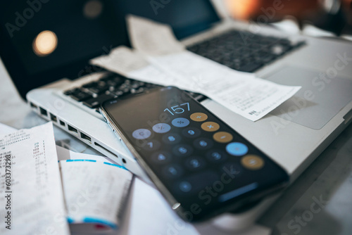 Close-up phone table with some bills, Planning budget and calculating expenses while checking her bills with calculator. 