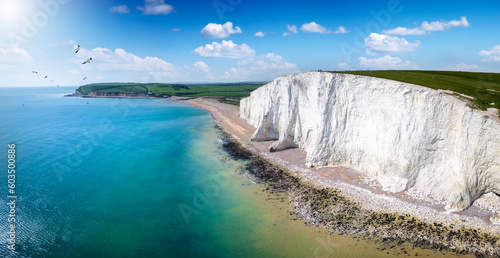 Panoramic aerial drone view of the famous Seven Sisters Chalk cliffs, Sussex, England, in early summer with sunshine and calm sea