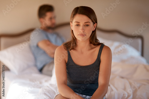 Sad, upset and couple in an argument in their bedroom for divorce or breakup in a modern house. Toxic, mad and face of a woman fighting and in conflict with her boyfriend in bed in their home.