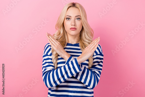 Portrait of serious confident girl with curly hairstyle wear striped pullover holding arms crossed isolated on pink color background