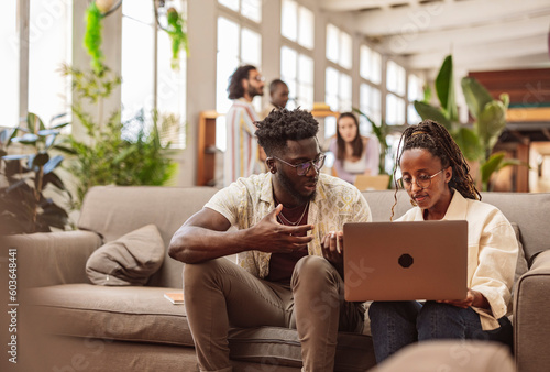 modern working room creative diverse young people divided into two groups with laptop, talking and discussing about project, multiracial students, roommates,