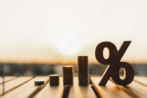 Percentage model with coins stack. Concepts of the banking system, rising interest rates, inflation, deflation, and savings.