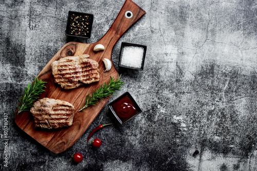 grilled veal steaks on stone background with copy space for your text
