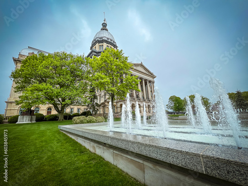 An ornamental water fountain sprays and splashes in front of the Illinois State Capitol Building in Springfield, Illinois, USA.