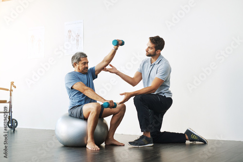 Dumbbells, physiotherapy and exercise with doctor and old man for rehabilitation, training and balance. Health, pain and healing with senior patient and physiotherapist for consulting, muscle or help