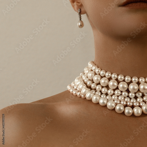 Beautiful young blondy woman with a lot of jewelry around her neck. Lots of pearl necklaces and bracelets.