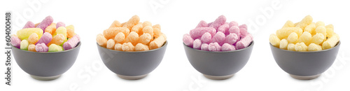 Set of bowls with colorful corn puffs on white background