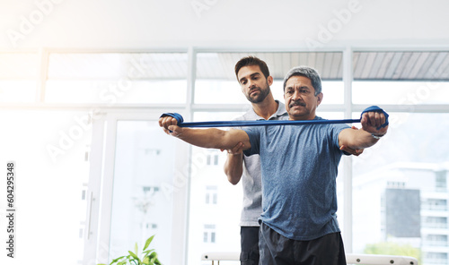 Physiotherapy, help and band with old man and doctor for training, rehabilitation and injury. Medical, healing and healthcare with physiotherapist and patient for consulting, stretching and fitness