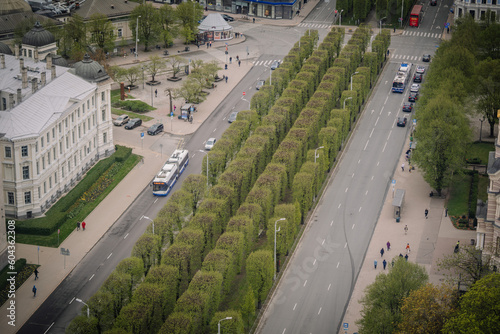 Aerial view of residential downtown traffic filled with bustling people and cars and awe-inspiring architecture.