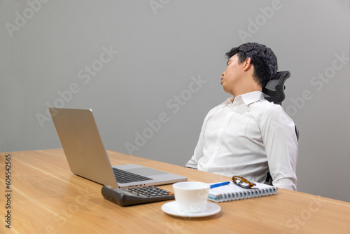 Man with narcolepsy is fall asleep on office desk..Narcolepsy is a sleep disorder that makes people very drowsy during the day.