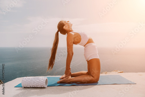 Woman sea pilates. Sporty middle-aged woman training in pilates on yoga mat by sea. concepts of health, wellness, and mindfulness in exercise, promoting the benefits of active and balanced lifestyle