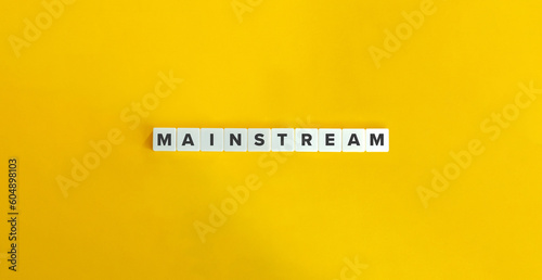 Mainstream Word on Block Letter Tiles on Yellow Background. Minimal Aesthetics.