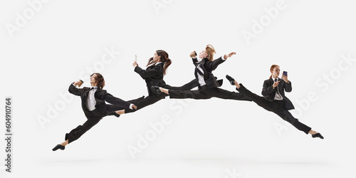 Portrait with group of beautiful women, ballet dancer in classical suit jumping in twine over white color studio background. Concept of business, office lifestyle, success