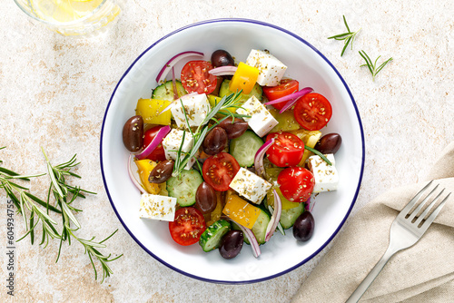 Greek salad. Vegetable salad with feta cheese, tomato, olives, cucumber, red onion and olive oil. Healthy vegetarian mediterranean diet food. Top view