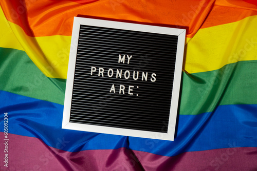 MY PRONOUNS ARE text Neo pronouns concept on Rainbow flag background gender pronouns. Non-binary people rights transgenders. Lgbtq community support assume my gender, respect pronouns tolerance equal