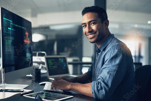 Portrait, man and smile of programmer on computer in office workplace at night. IT, face and male coder or person programming, coding and writing for software development or information technology.