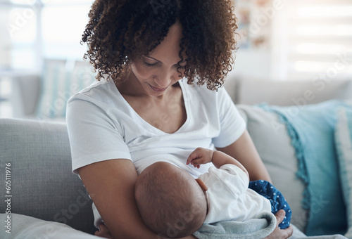 Love, living room and mother breastfeeding her baby for health, nutrition and wellness at home. Bonding, care and young woman nursing or feeding her newborn child milk on the sofa in the family house