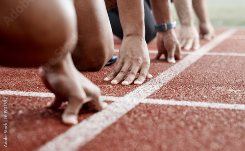 Ground, hands and people ready for a race, running competition or training at a stadium. Fitness, sports and athlete runners in a line to start a sprint, exercise or challenge in track or athletics