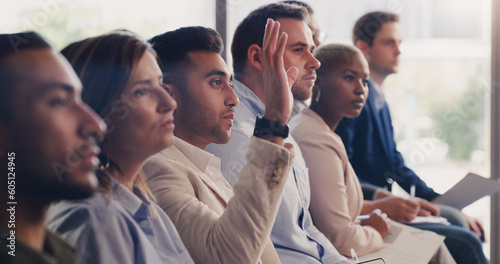 Audience, conference and question of a business man with hand up at a seminar, workshop or training. Diversity men and women crowd at a presentation for learning, knowledge and faq discussion