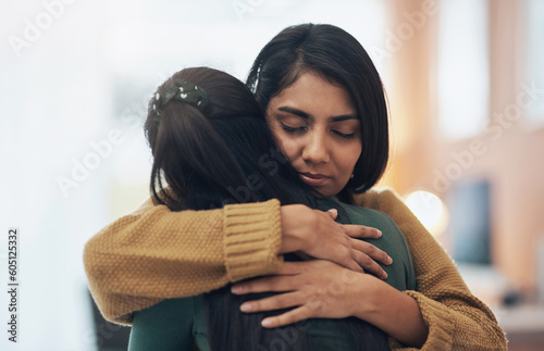 Friends, hug and support of women together in a house with love, care and empathy. Indian sisters or female family in a room while sad, depressed and hugging for comfort, trust and quality time