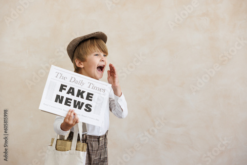 Newsboy shouting against grunge wall background. Boy selling fake news