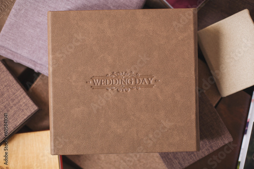 Wedding photobooks in brown leather binding. Wedding photo book, album family album. Photo books with embossing and a cover of genuine leather. Services of a professional photographer and designer. 