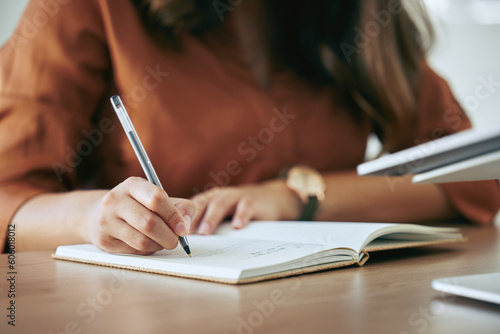 Writing, planning and hands with a notebook for a strategy, goal or professional schedule at a desk. Business, working and a secretary or receptionist with a book for an agenda, plan or an idea