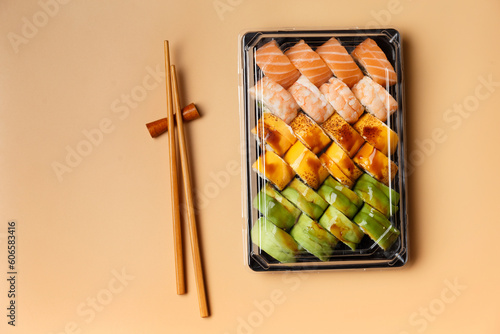 Set of sushi rolls in plastic packages on a light background, top view.
