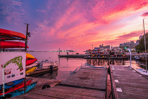 sunset sets the sky on fire over boat racks in toronto inner harbour with billy bishop airport in the background shot in in summer