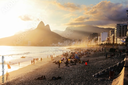 Crowd of people enjoying the majestic sunset at Ipanema beach in Rio de Janeiro, Brazil