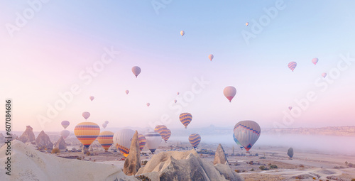 Landscape sunrise in Cappadocia with set colorful hot air balloon fly in sky with sun light. Concept banner tourist travel Goreme Turkey