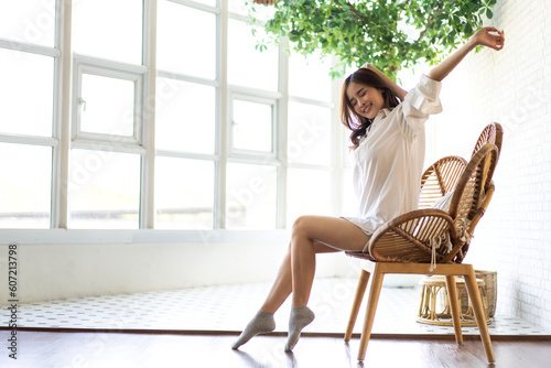 Portrait of smiling beauty pretty asian woman comfortable fresh healthy smile happy and relax in pajamas white clothes, happy calm, resting, breathing fresh air.Girl felling wellbeing enjoy at home