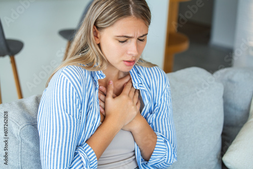 Young woman having chestpain,Acute pain, possible heart attack.Effect of stress and unhealthy lifestyle concept.