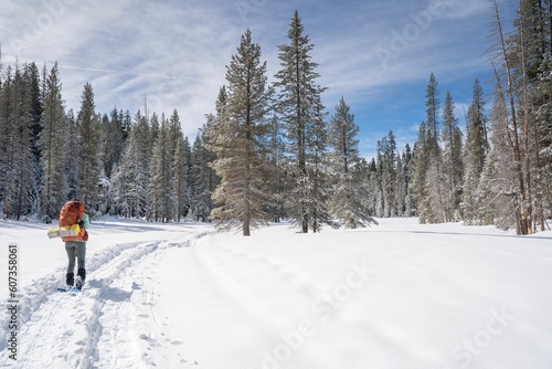 Hiker snowshoe camping on a trail in Yosemite National Park on the way to Dewey Point