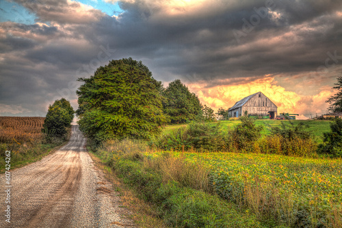 Barn under a stunning cloud along a gravel road in rural Missouri 