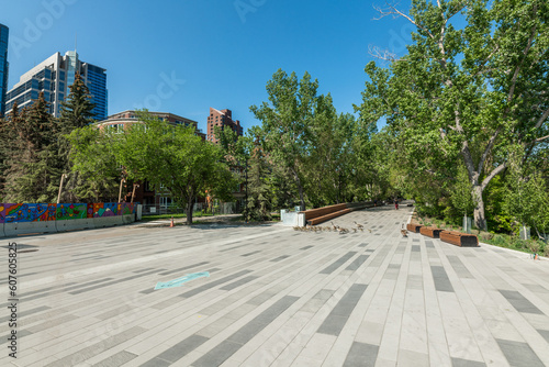 Scenic views along the Bow River pathway area for pedestrians, bicycles during summer spring on beautiful blue sky day.