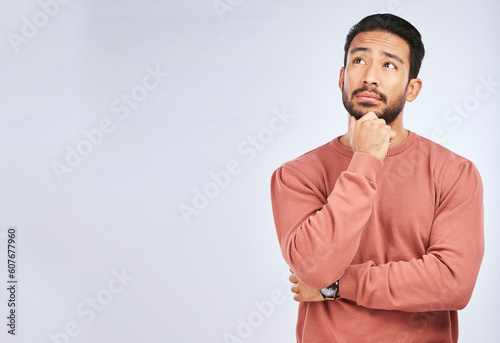 Man, thinking and idea mockup in studio or planning, decision and choice with white background. Asian male, model and curious face with doubt, questions or confused guy try to remember with space