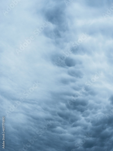 Dramatic blue sky with clouds. Spooky abstract background pattern texture. Horror, Halloween, evil, armagedon, apocalypse concept.