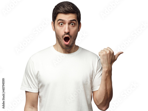 Young surprised man in white t-shirt pointing right with his finger, shouting WOW. Shock content